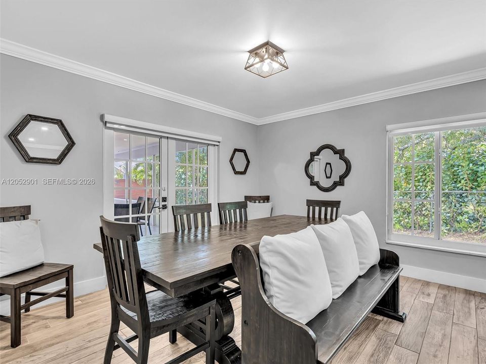 Spacious dining room with French impact doors out to the patio