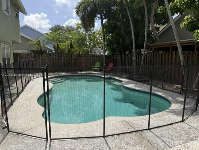 Free form pool with child safety fence
