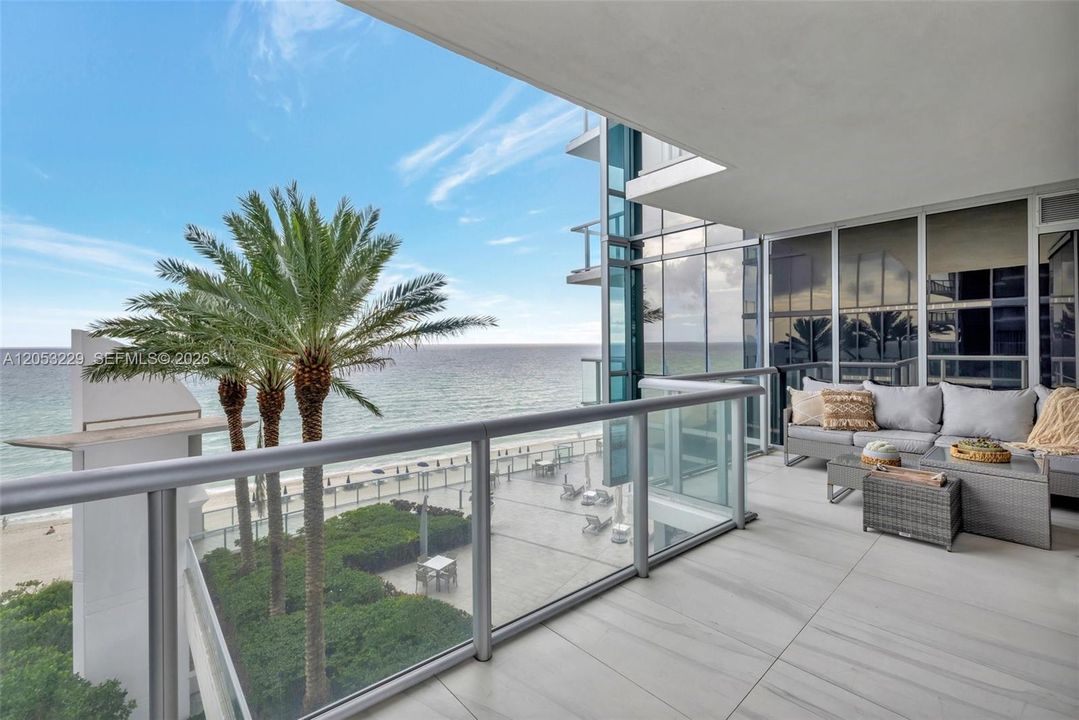 Private balcony overlooking the pool and ocean. Furniture shown has been replaced with new balcony furniture.