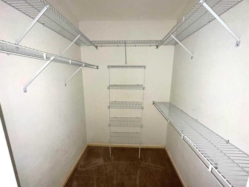 ONE OF TWO WALK-IN MASTER CLOSETS
