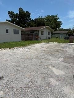 Two paved parking spots with room for additional car
