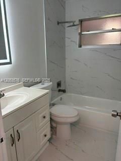 Remodeled guest bathroom with tub/shower and floor to ceiling custom tile