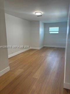 Separate large living room area with new wood laminate flooring