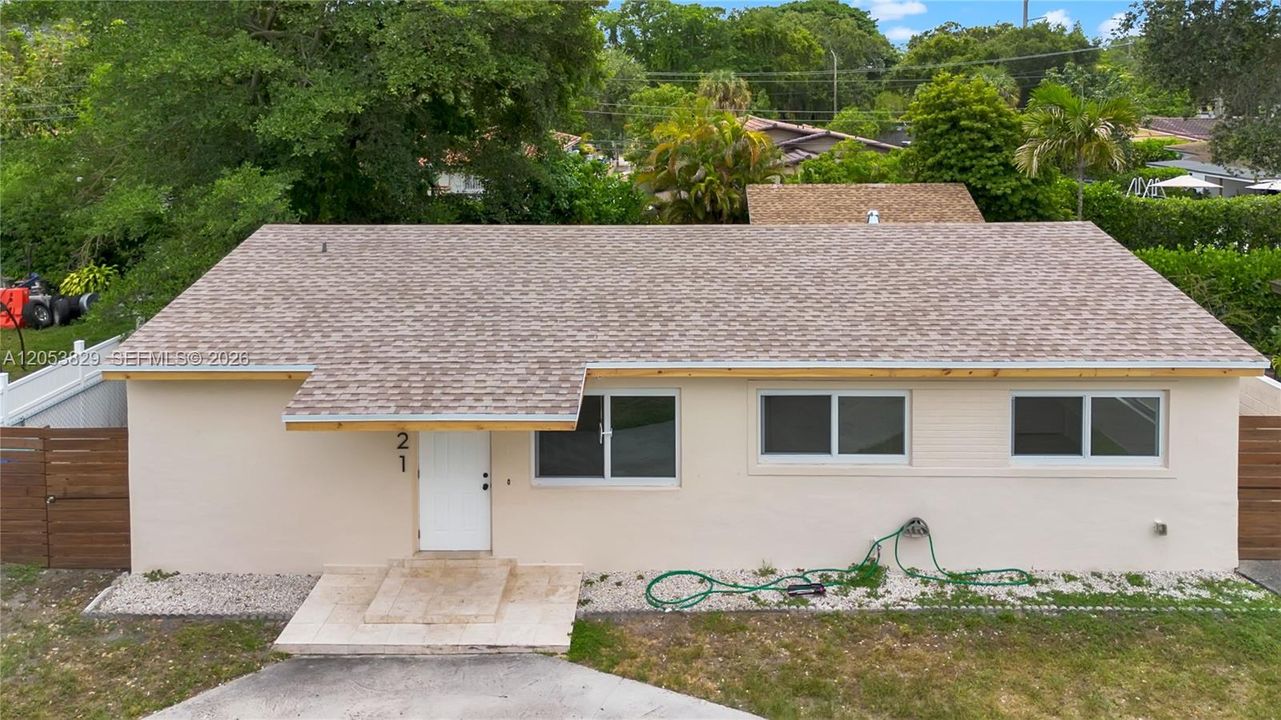 Front aerial view highlighting the home's new roof and updated exterior.
