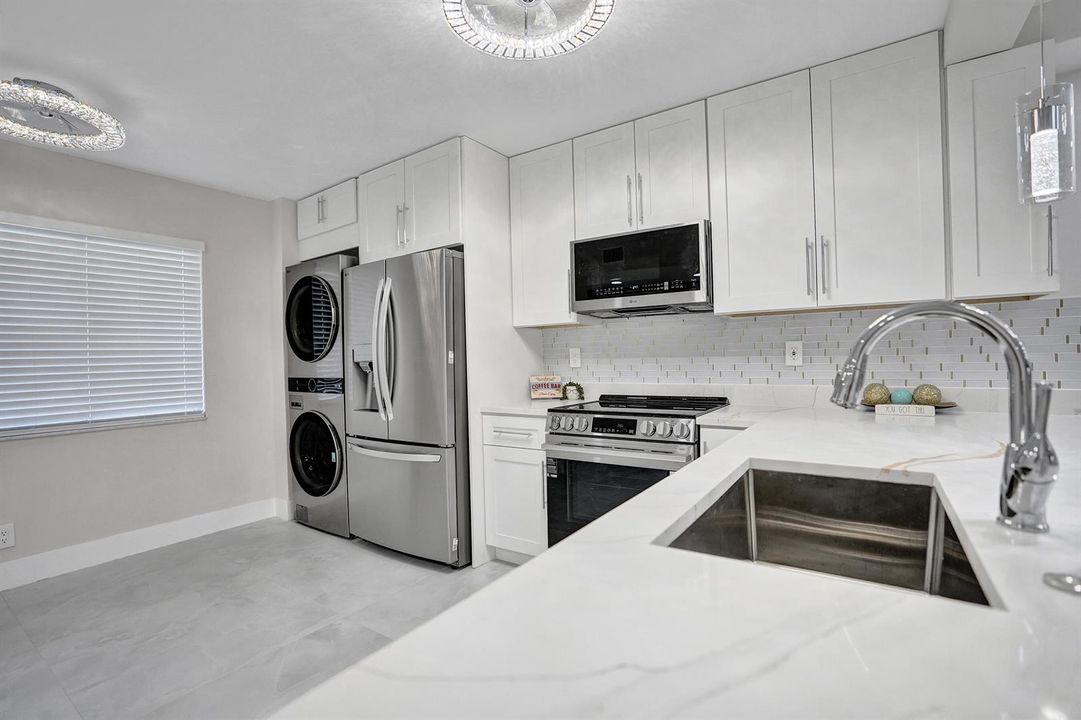 renovated condo kitchen with quartz coun