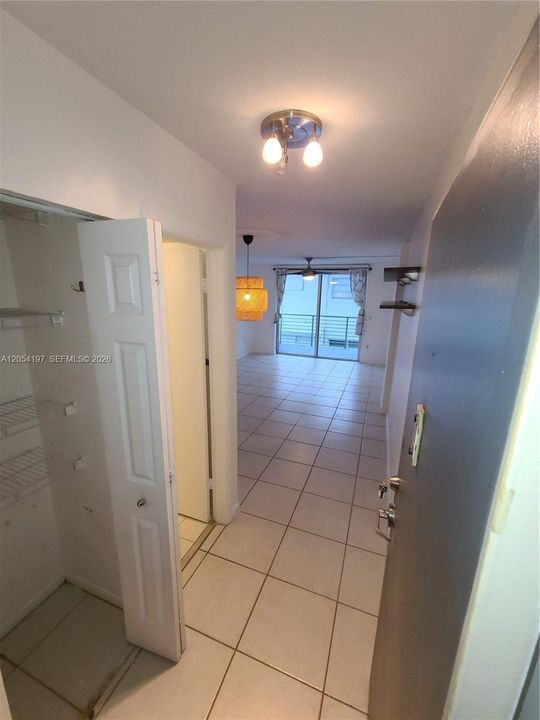 Guest bathroom on the left, entering the unit