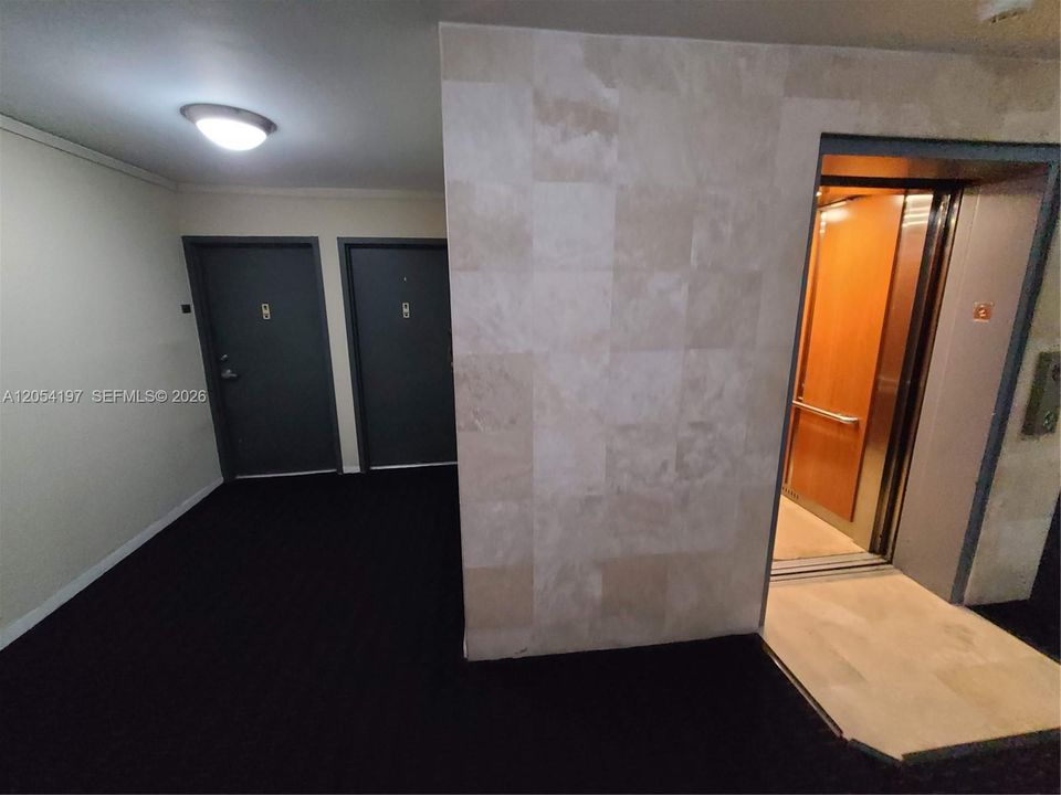 Extra closet & guest bathroom on the left, entering the unit