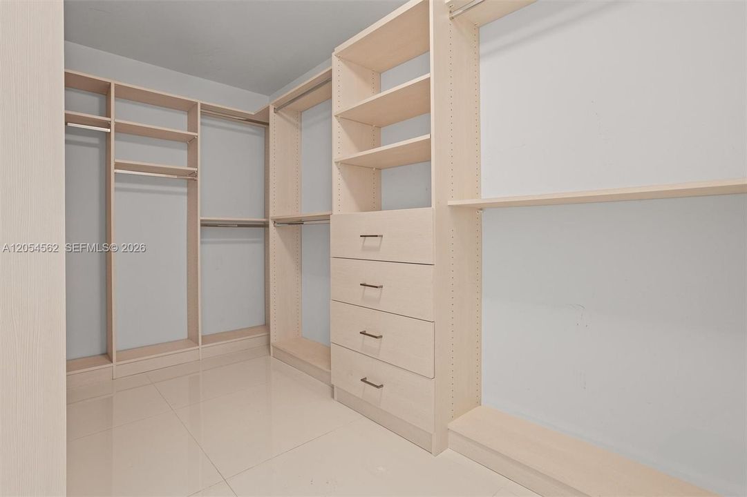 Custom walk-in closet with built-in shelving and drawers