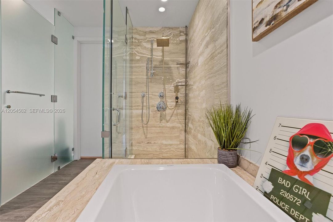Walk-in glass shower with floor-to-ceiling tile and modern fixtures
