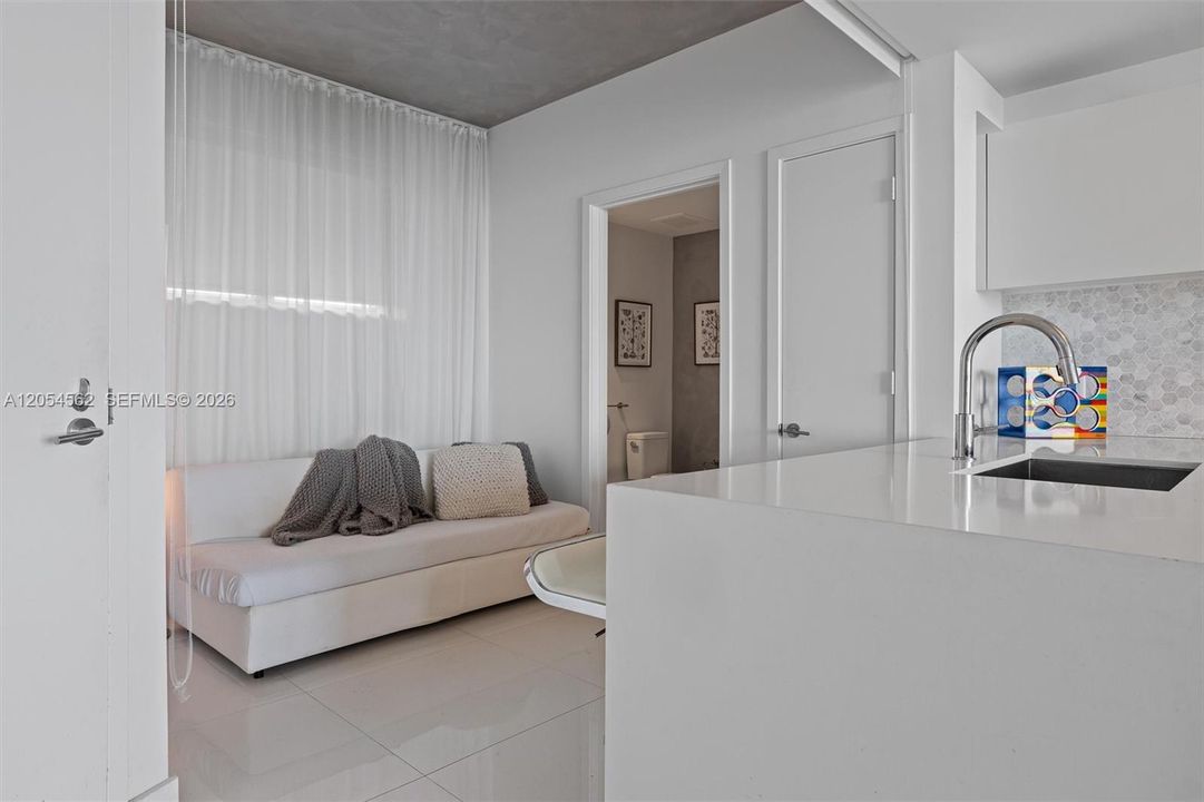Spacious living area with wet bar and abundant natural light