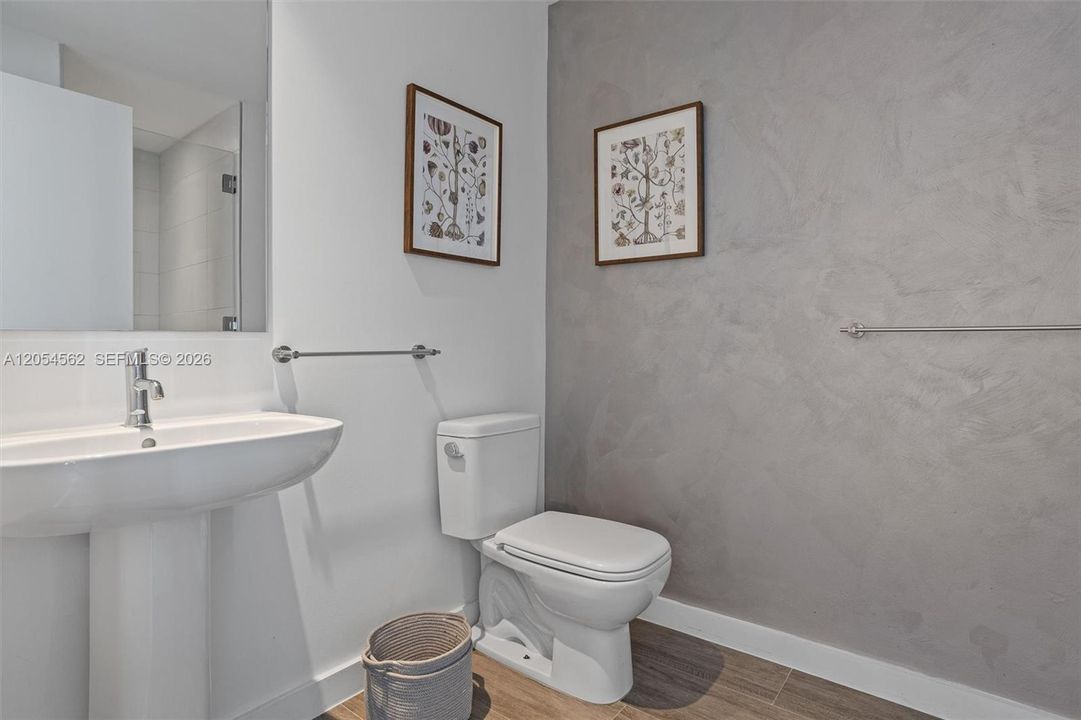 Well-appointed bathroom with designer finishes and framed art