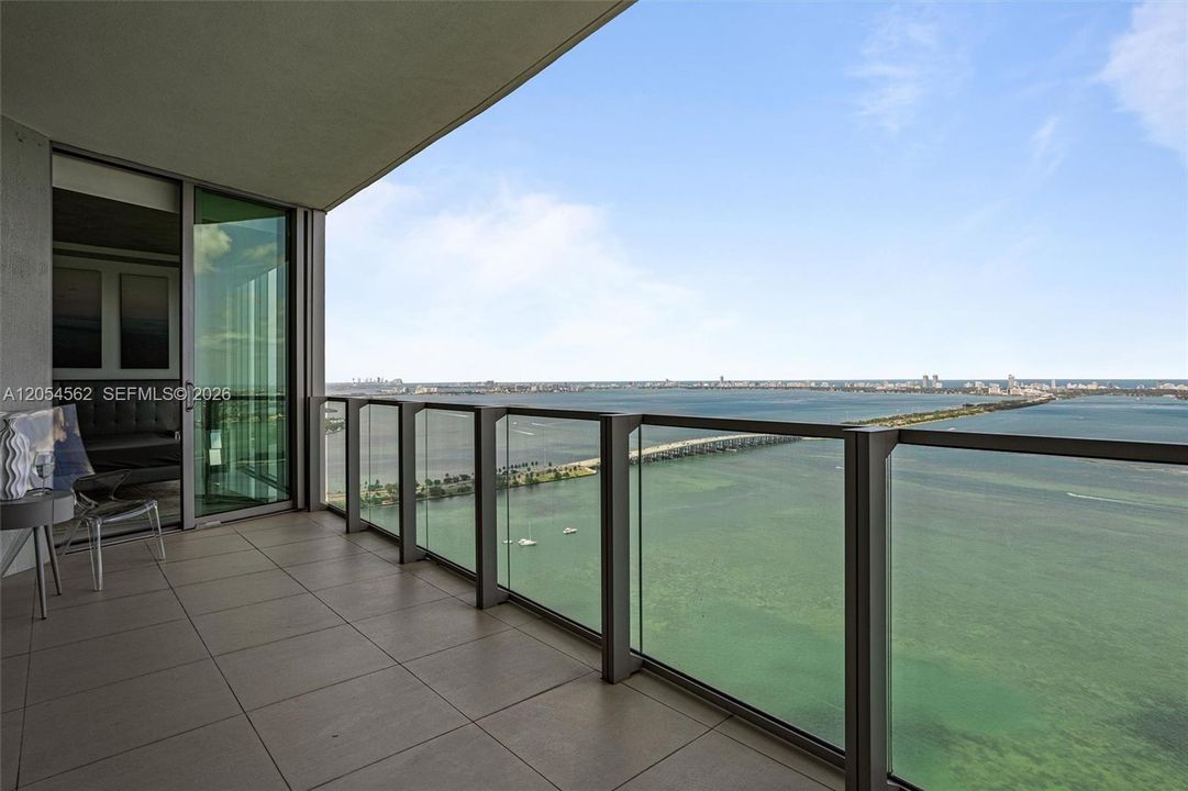 Glass-railed balcony with unobstructed water views in Edgewater, Miami