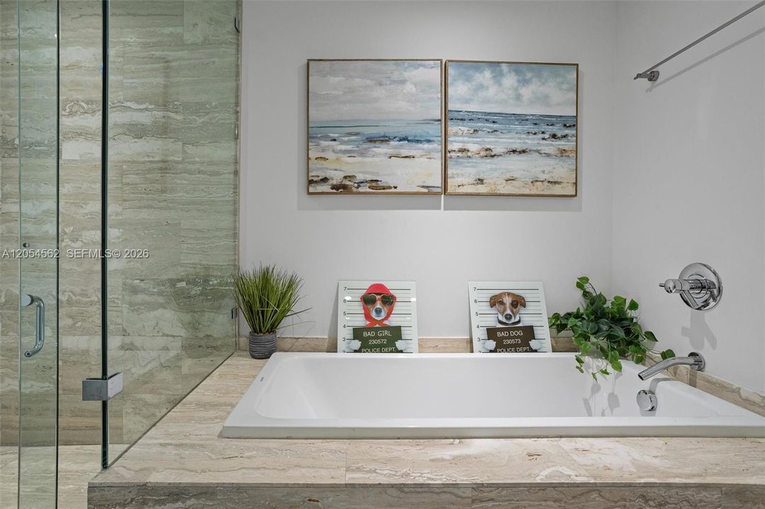 Spa-inspired bath with soaking tub and glass-enclosed shower