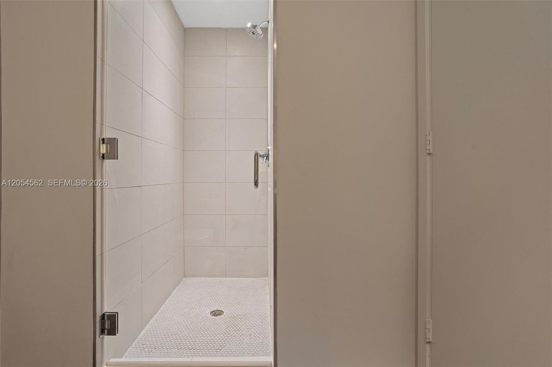 Additional full bathroom with walk-in shower and neutral palette
