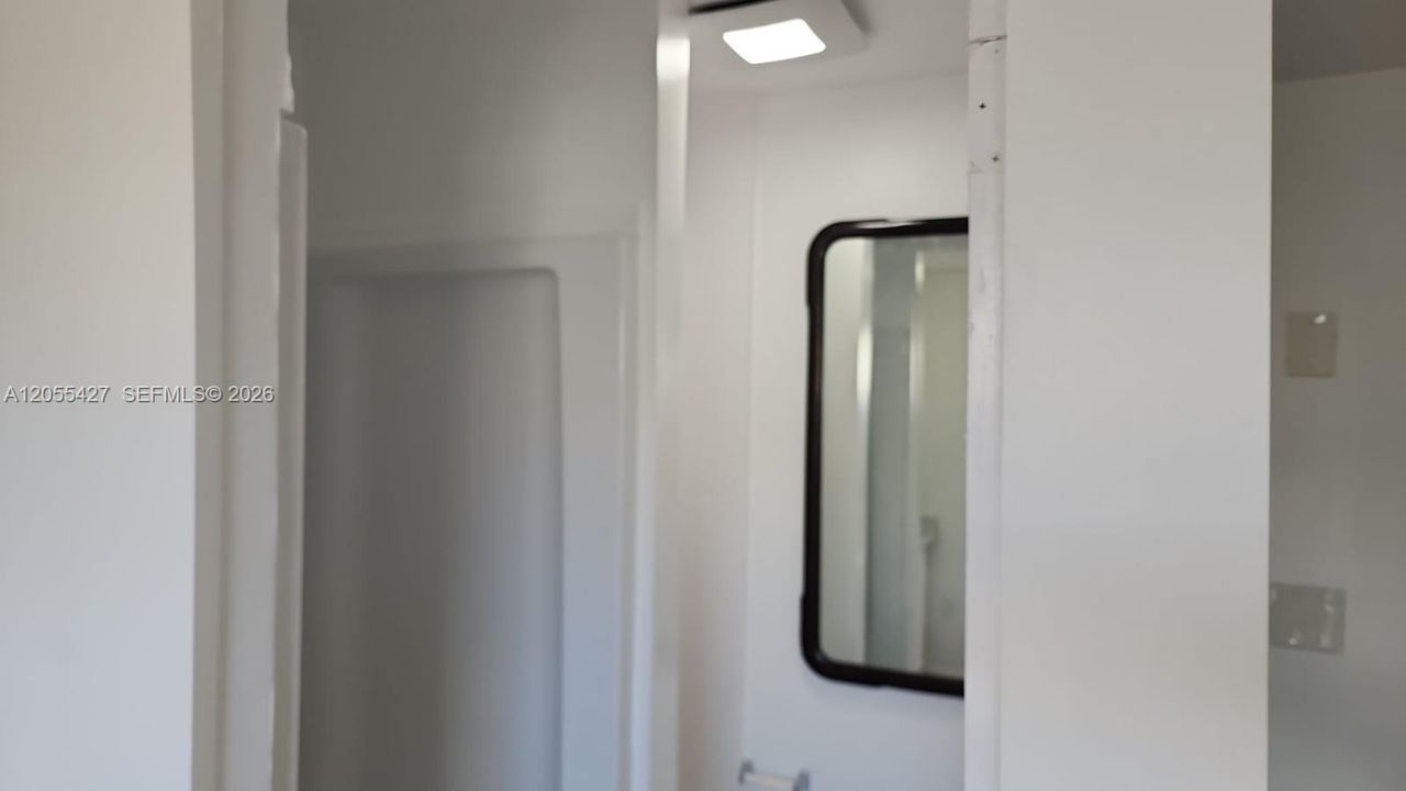 Baño moderno y funcional: Un espacio impecablemente diseñado que combina limpieza y modernidad. Esta vista permite apreciar la fluidez del diseño hacia la sala de estar, destacando la excelente distribución de la unidad y la atención al detalle en cada área para ofrecer una experiencia cómoda y práctica.