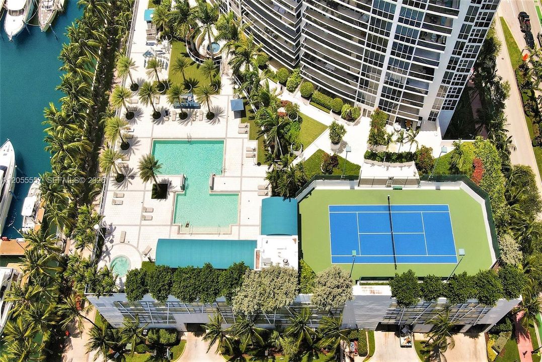 Scenic Spacious Pool Deck with full-size tennis court and restaurant overlooking Biscayne Bay.