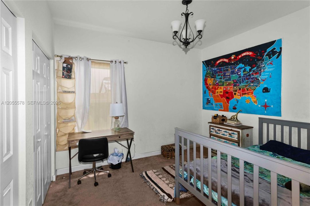 Full of character and charm, this well-lit bedroom features a unique, educational touch and a dedicated study area, making it an inspiring space perfect for growing minds