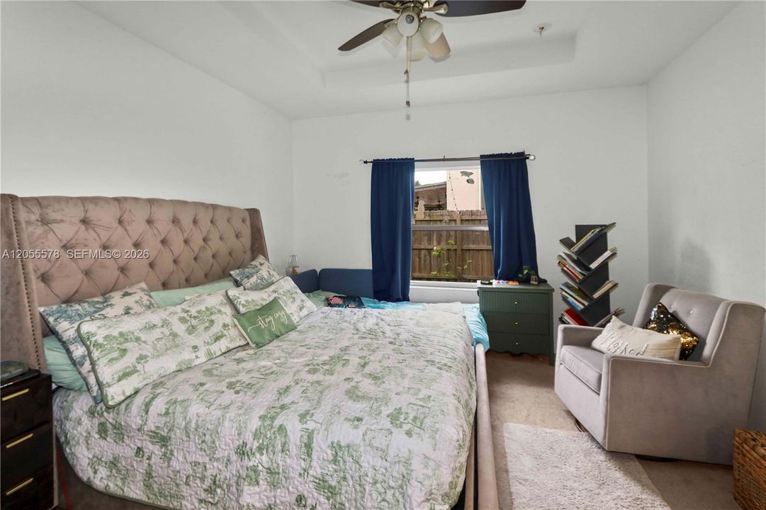 Generous space and comfort! This secondary view of the primary bedroom showcases its versatile layout and cozy atmosphere, making it a truly relaxing retreat.