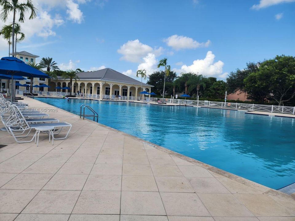 Resort-style living in your own community! Dive into luxury with this stunning, oversized community pool surrounded by ample lounge space, perfect for soaking up the Florida sun and relaxing outdoors.