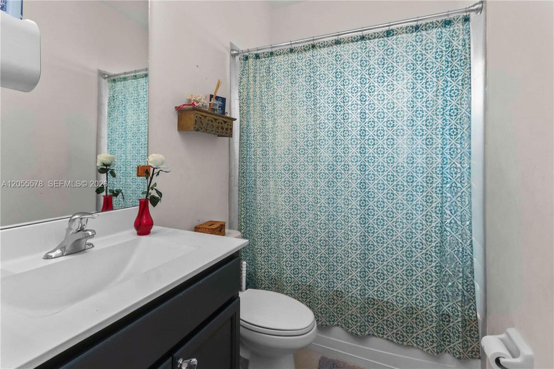 Immaculately maintained, this guest bathroom offers a modern, crisp design with quality finishes, providing a comfortable and inviting space for family and visitors alike