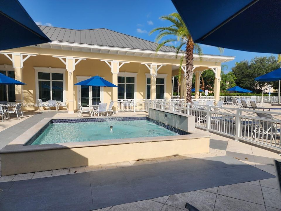 Ample space and comfort under the sun. Another angle of this spectacular community pool, featuring plenty of space for swimming or simply lounging peacefully.