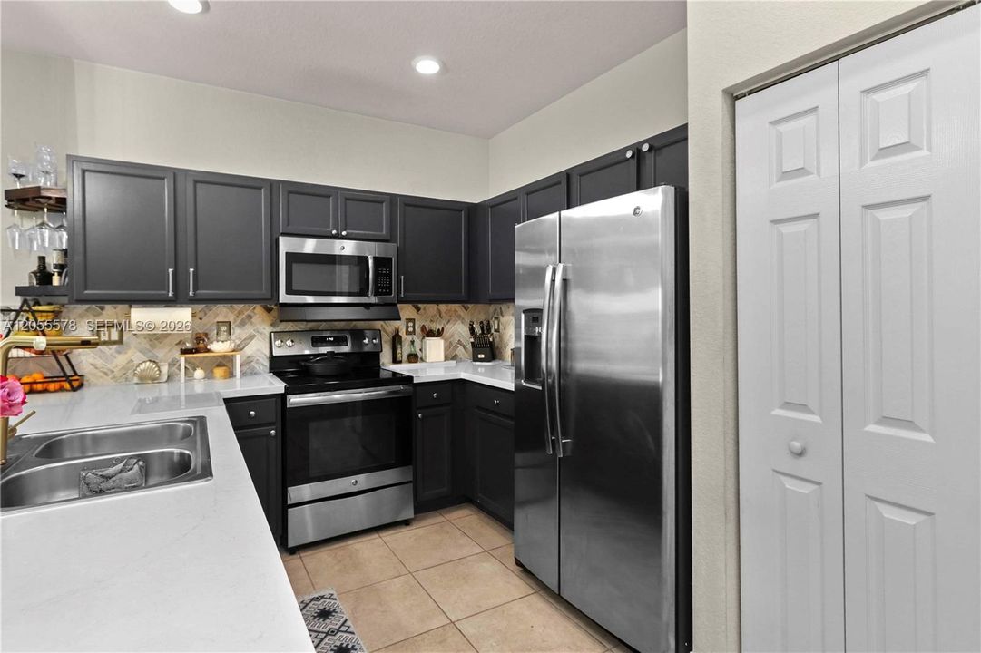 Modern efficiency meets functionality! This well-appointed kitchen offers ample cabinetry and convenient storage, ensuring everything you need is organized and within reach