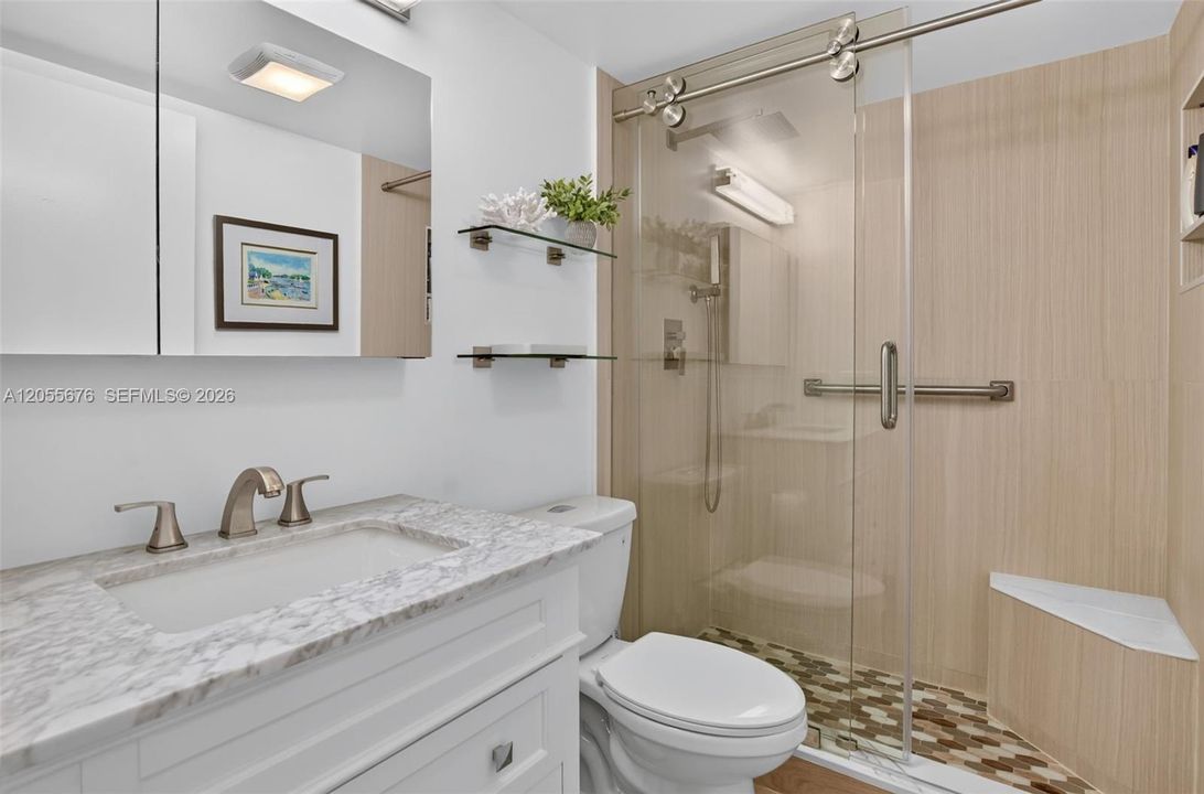 Spa-like bathroom with rain showerhead and handheld wand.