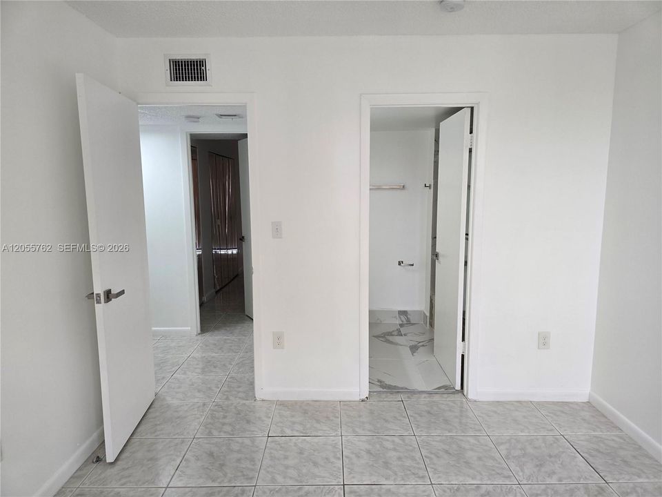 The second bedroom offers an en-suite bath