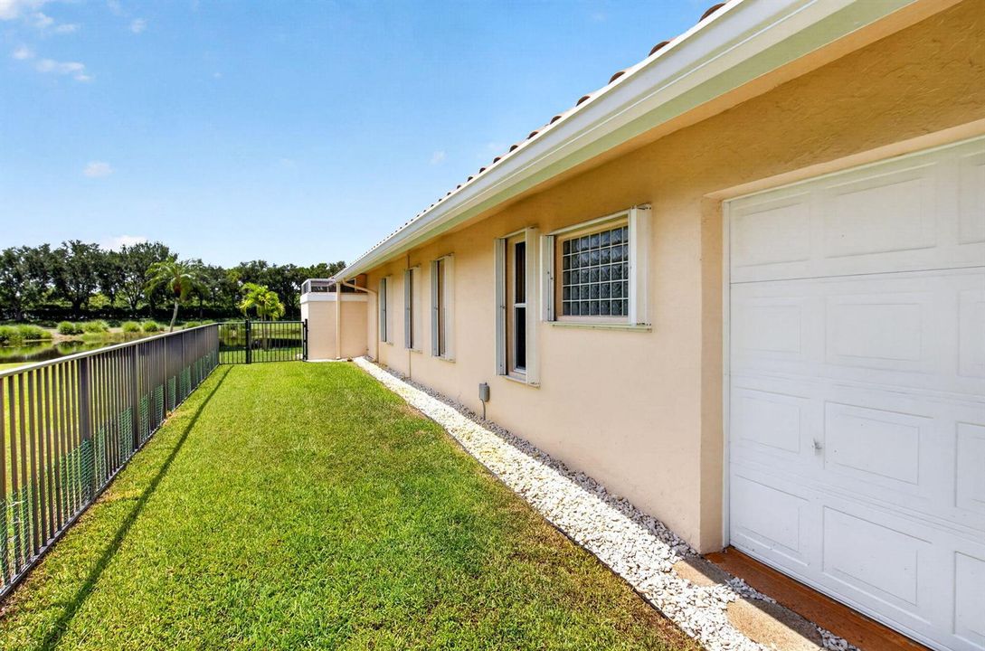 side fenced yard with golf cart garage