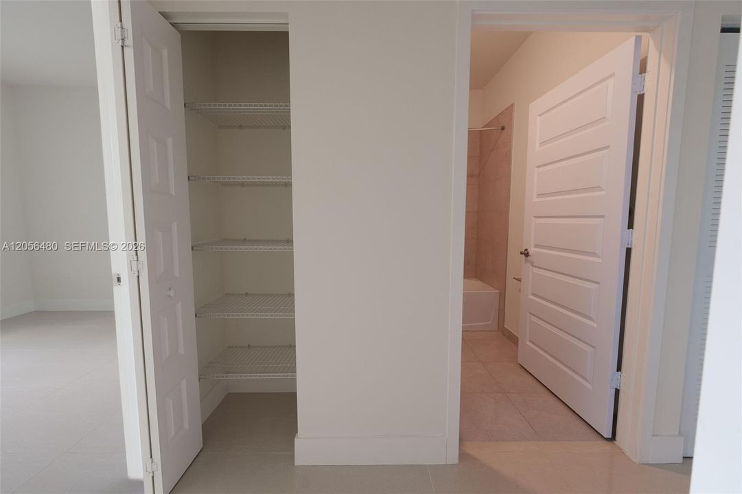 Hallway closet and guest bathroom