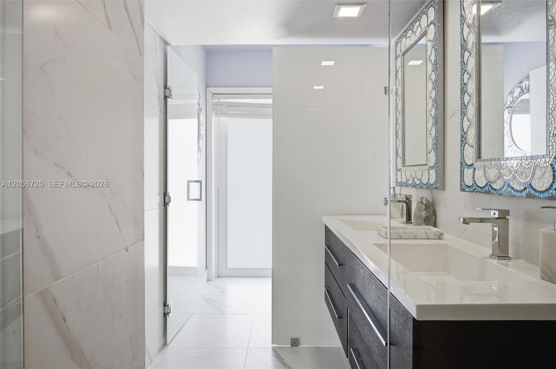 Dual sinks overlooking water closet w/ bidet