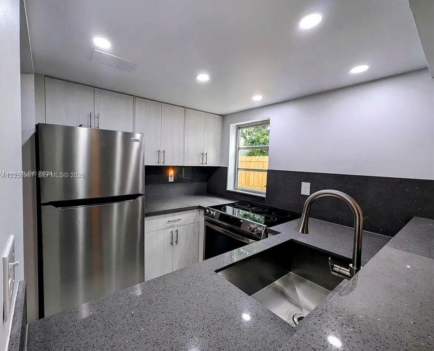 Kitchen with Granite Counters and New Appliances