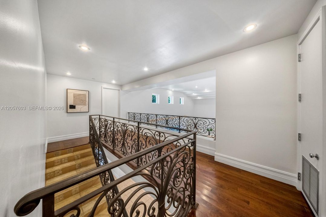 landing at the top of the stairs between the primary and other  2 upstairs bedrooms
