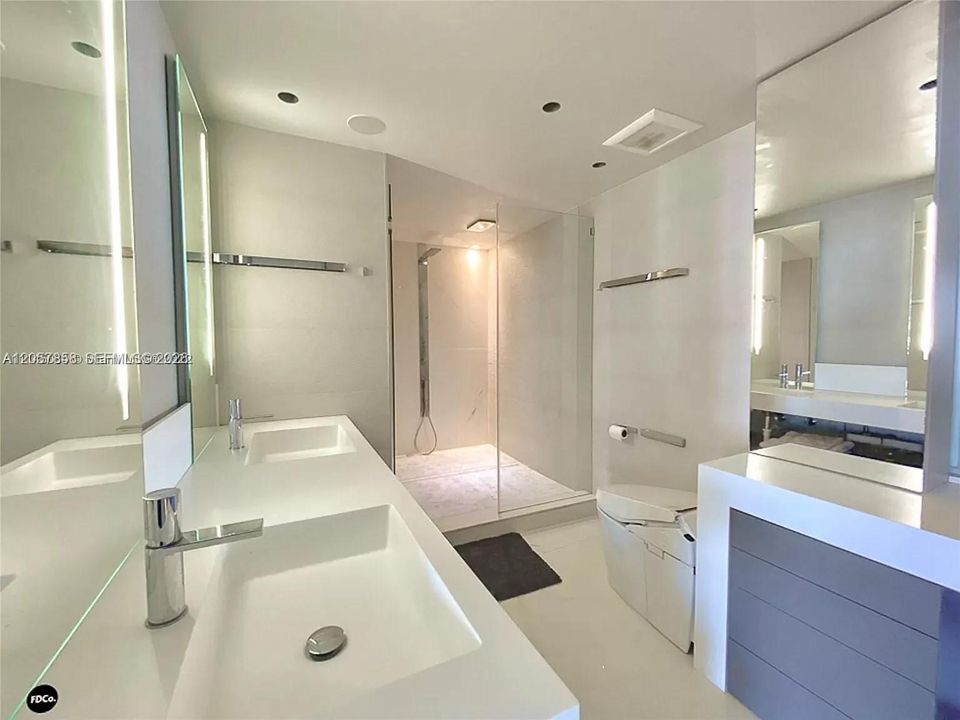 Master bathroom with multiple showers and double sinks