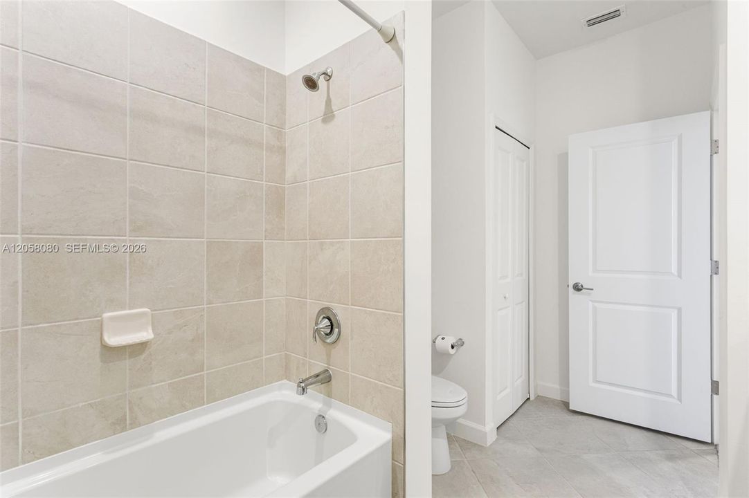 Upstairs second full bathroom featuring a tub/shower combination, ideal for family or guests