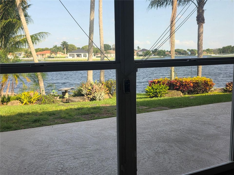 View of back yard and lake from Florida room
