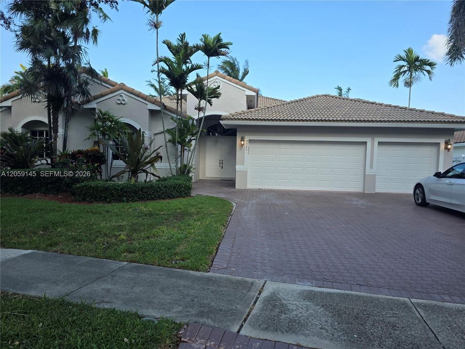 Front view of home and  three car garage