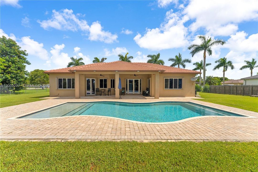 DAYTIME VIEW OF POOL AND ENORMOUS PATIO