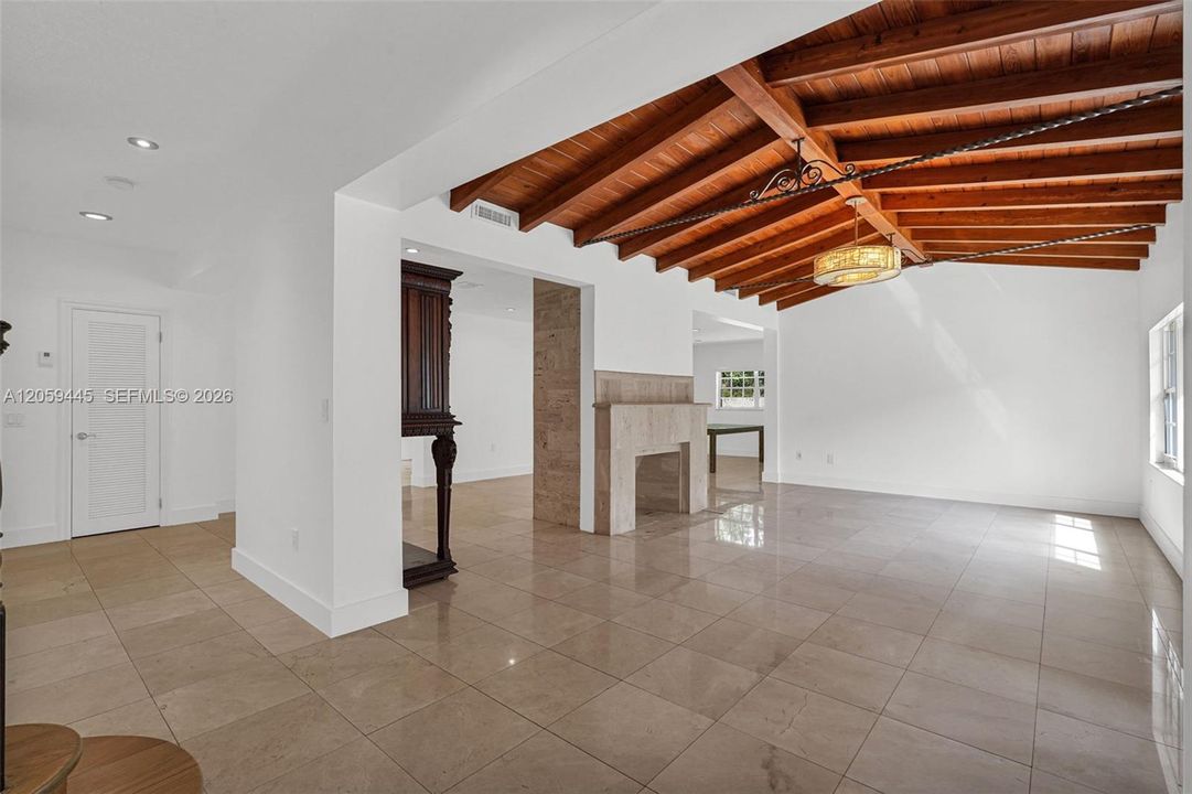 Formal Living Room | vaulted wood beam ceiling | Panoramic Windows | Decorative Fireplace