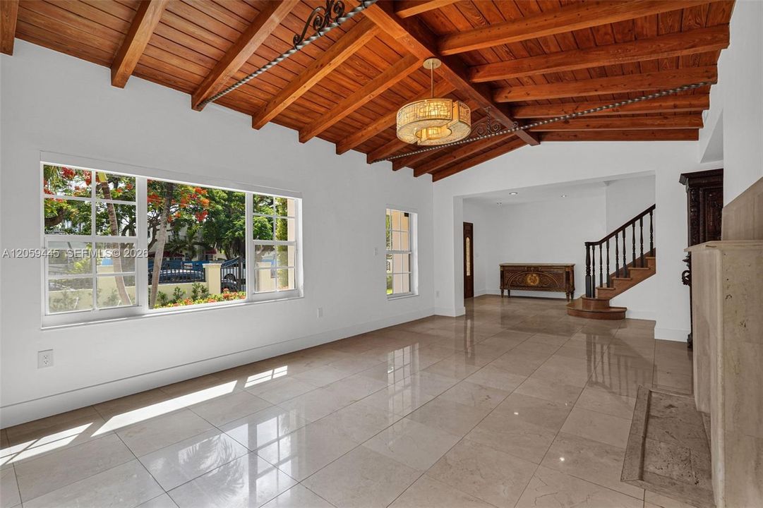 Formal Living Room | vaulted wood beam ceiling | Panoramic Windows | Decorative Fireplace