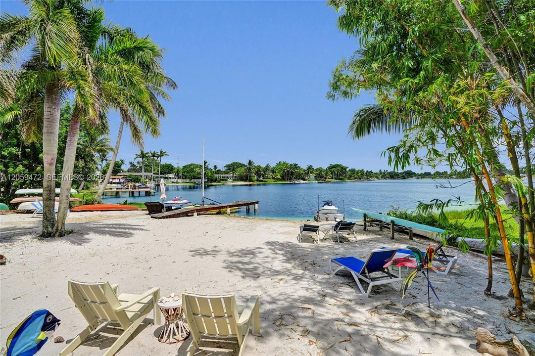 Private sandy waterfront with lounge seating right on the water — come home to your own slice of paradise every day. Furniture not included.
