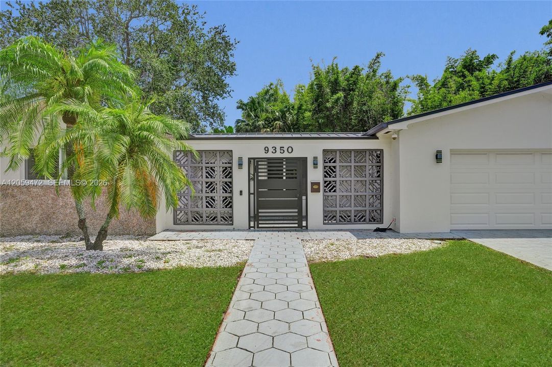 Centrally located with great neighbors, this home welcomes you with a paver walkway and lush front yard.