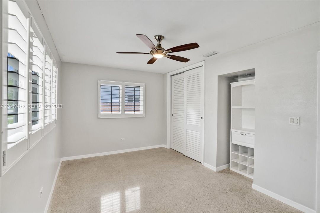 large bedrooms, terrazo floors, built-ins. Plantation Shutters. and impact windows.