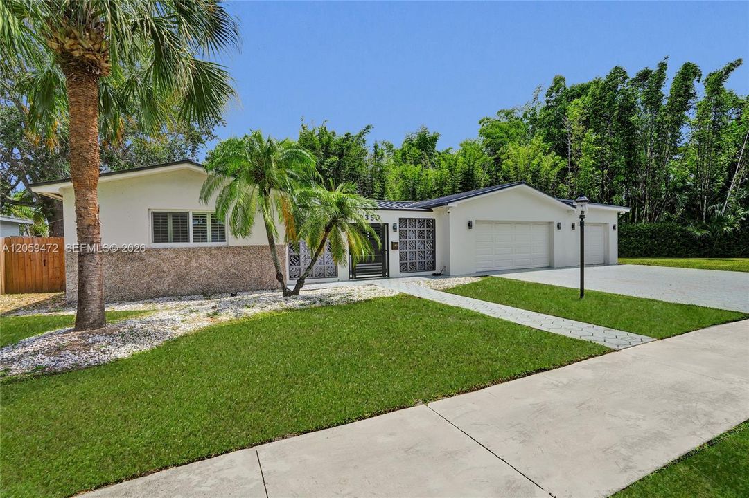 Centrally located with great neighbors — a clean, well-maintained exterior framed by mature palms.