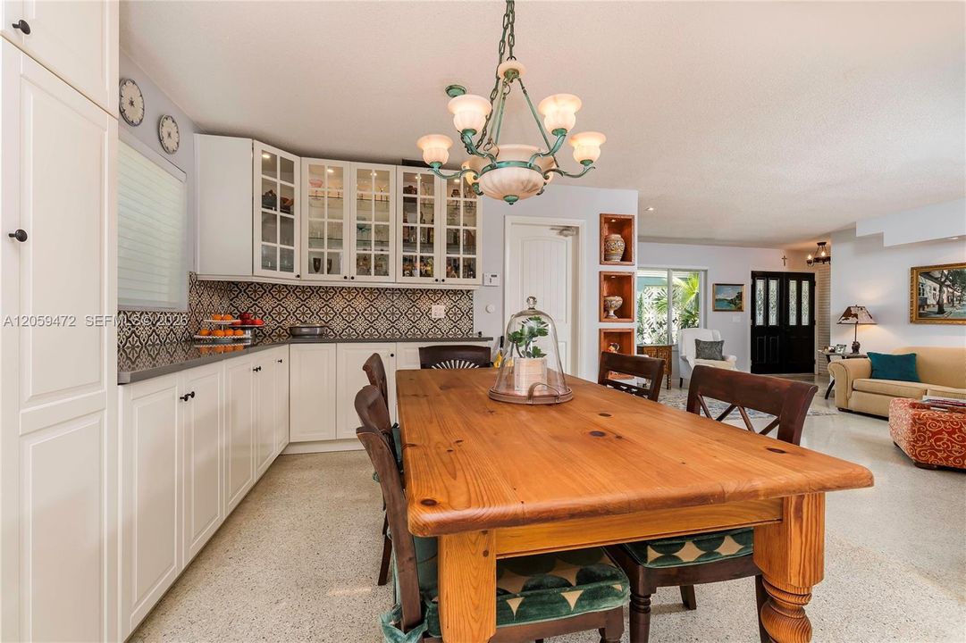 Charming dining nook featuring a farmhouse-style table and chandelier, with an easy flow into the adjacent kitchen. FYI - Some paint colors have changed since the last pictures.  Furniture, some lighting fixturs, & personal items not included in the rental
