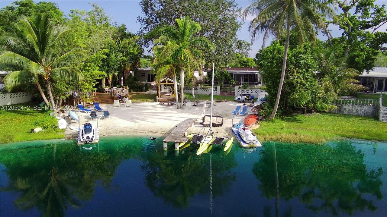 Private lakefront beach and dock, offering direct water access for boating, swimming, or simply soaking in the view. Lakefront beach and dock, on your very own motorized lake