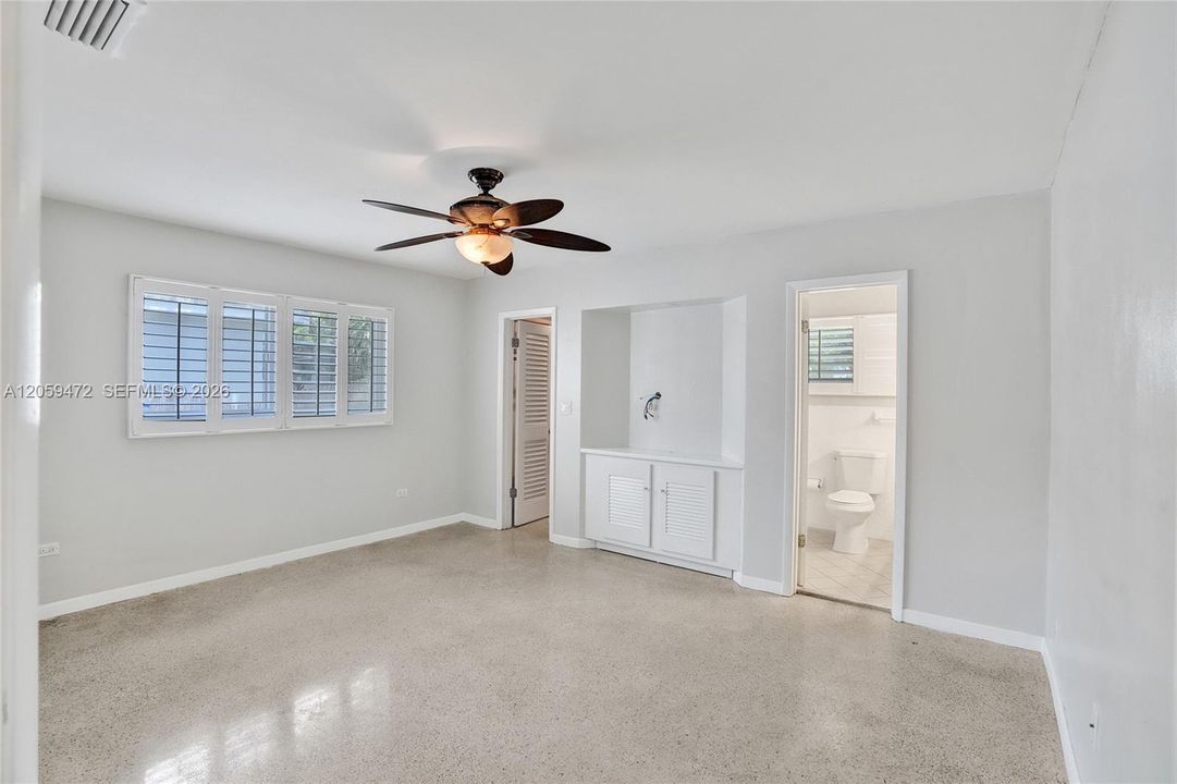Large master bedroom with cedar-lined closet, ceiling fan, and abundant natural light.