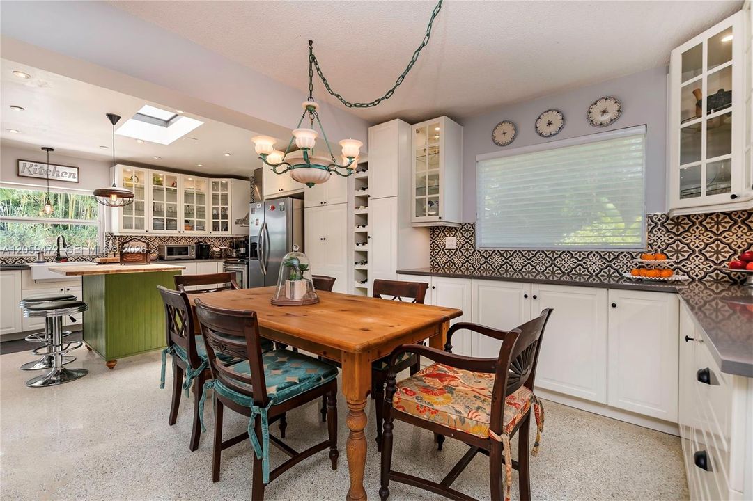 Open dining space with skylight and pendant lighting, seamlessly connected to the kitchen — perfect for casual meals or entertaining. FYI - Some paint colors have changed since the last pictures.  Furniture, some lighting fixtures  & personal items not included in the rental