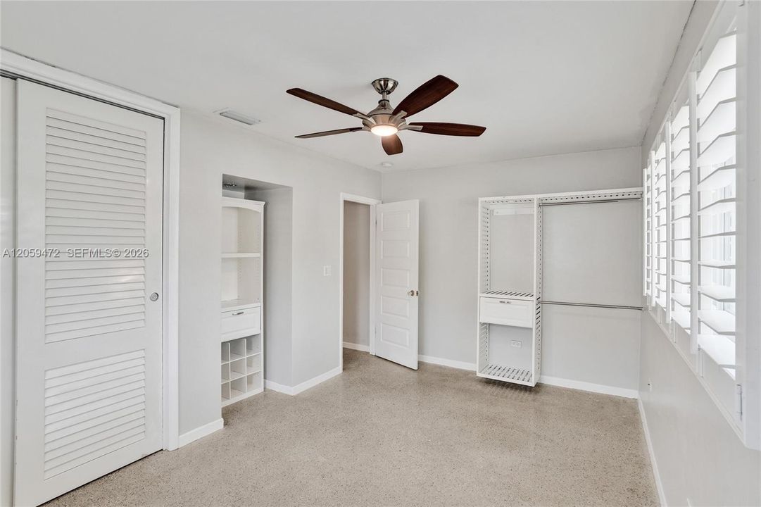 Spacious bedrooms, light colors, terrazo floors and plantation shutters.