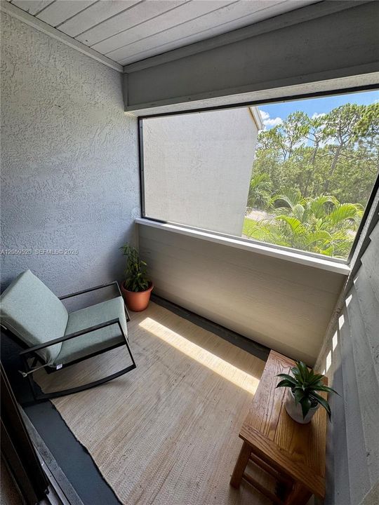 Private screened-in balcony off of the primary bedroom